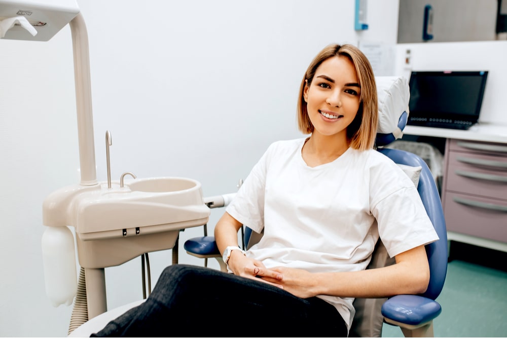 Portrait of attractive caucasian woman sit in dentist office