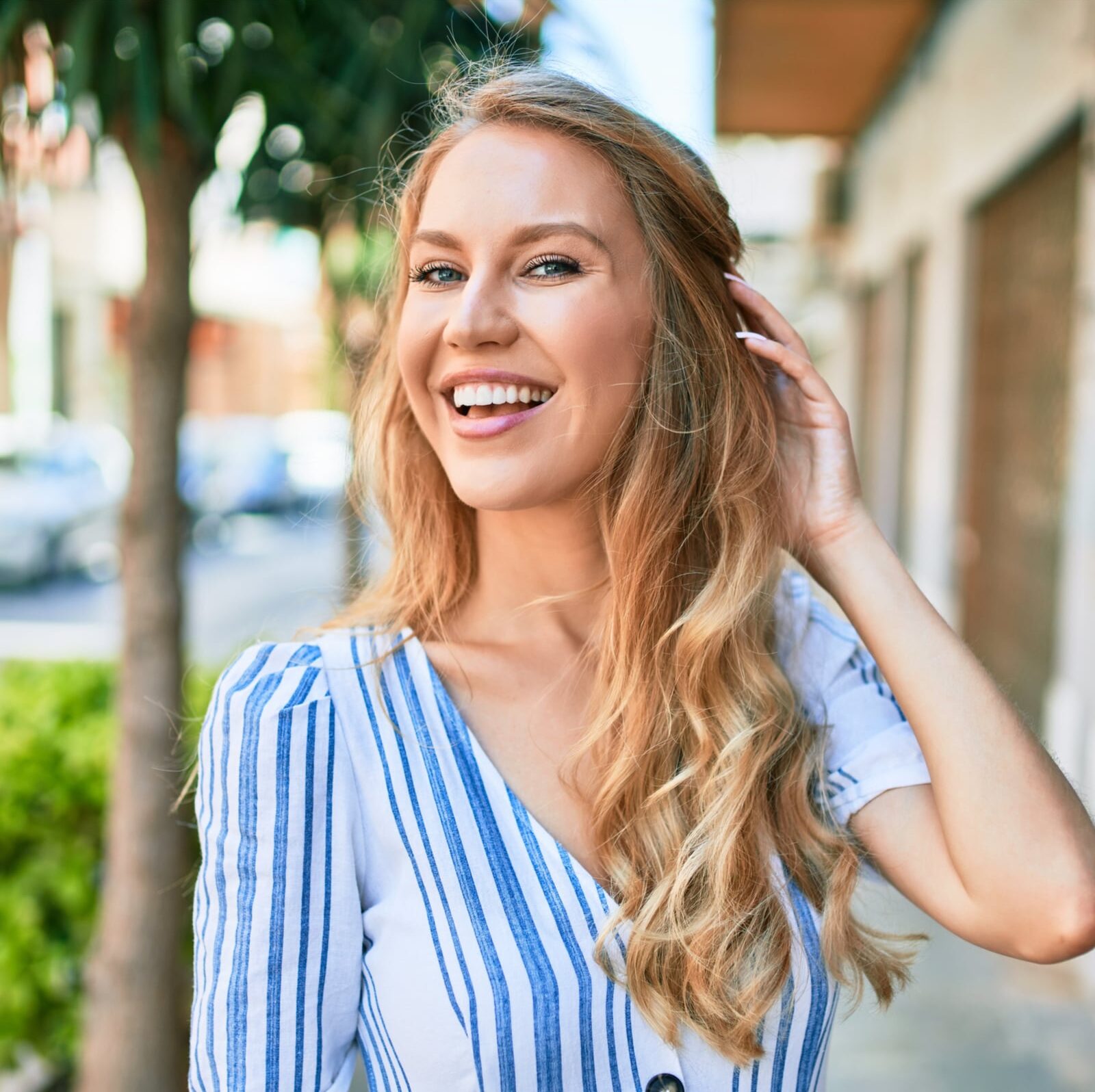Young beautiful caucasian woman with blond hair smiling